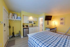 a bedroom with a bed and a kitchen at Ocean City Condo with Pool Walk to Boardwalk! in Ocean City