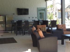a restaurant with chairs and a table and a bar at HONU KAI - 3 Bedroom Townhouse townhouse in Jekyll Island