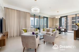 a living room with a couch and chairs and a table at Dream Inn Apartments- Boulevard Heights in Dubai