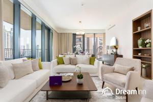 a living room with white furniture and large windows at Dream Inn Apartments- Boulevard Heights in Dubai