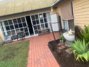 a house with a brick walkway in front of a patio at cottage of character in Sunbury