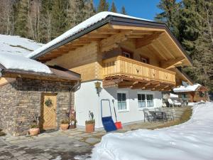 a house with a wooden roof in the snow at Holiday house, Flachau in Flachau