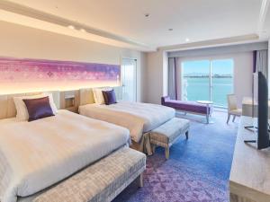 a hotel room with two beds and a television at Grand Nikko Tokyo Bay Maihama in Urayasu