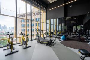 a gym with treadmills and exercise bikes in a building at Opus KL Residences by Premium Hospitality in Kuala Lumpur