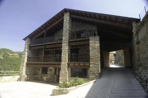 a large building with a balcony on top of it at L'Era de Cal Bastida in Estamariu