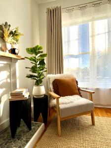 a living room with a chair and a plant at Walnut House Mildura in Mildura