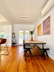 a dining room with a table and chairs at Walnut House Mildura in Mildura