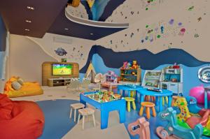 a childs room with a wave painted on the wall at Novotel Phuket Kata Avista Resort and Spa in Kata Beach