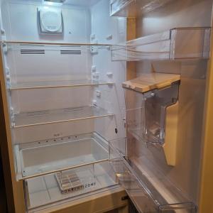 um frigorífico vazio com a porta aberta numa cozinha em Appartement tout prés du centre avec chambre et salon équipé d'internet em Brest