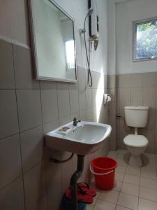 a bathroom with a sink and a toilet at Warisan Family inn @ Seafront in Semporna