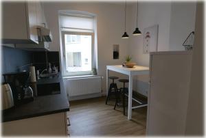 a kitchen with a sink and a counter top at Gemütlich - 2 Zimmer-Altbau, 24h Check-in in Kiel