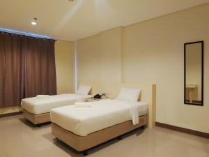 Ένα ή περισσότερα κρεβάτια σε δωμάτιο στο Kaizen Suites