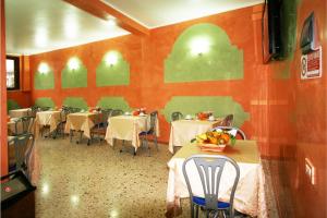 a restaurant with tables and chairs in a room at Hotel Cortese in Palermo