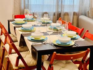 a table with wine glasses and plates on it at La Latina Premium Home in Madrid