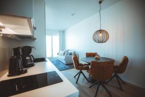a kitchen and dining room with a table and chairs at Apukka Rovaniemi City Apartments in Rovaniemi