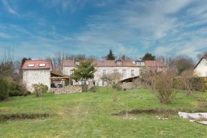 a large house on a hill with a field at Maison Valeli - Maison de charme à 1h de Paris in Lavilletertre +8 photos