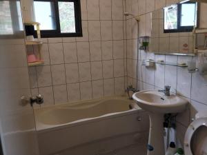 a bathroom with a sink and a tub and a toilet at Meiting B&B in Shuili