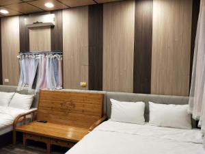Habitación con 2 camas y mesa con almohadas blancas. en Meiting B&B, en Shuili