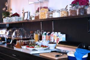 a kitchen with a counter with food on it at Hotell Drott in Norrköping