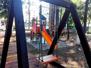 a swing set in a park with a playground at Biancopineta in Marina di Montenero
