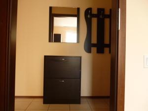 a black dresser in a room with a mirror at Apt. Plovdiv in Plovdiv