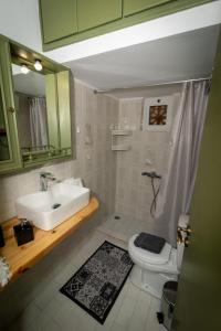 a bathroom with a sink and a toilet at Vintage Guest House in Monemvasia