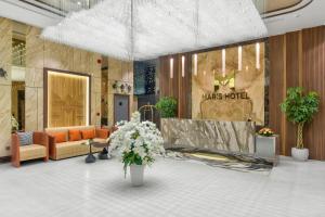 a lobby with a store with couches and flowers at Maris Hotel Nha Trang in Nha Trang