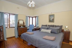 a bedroom with a large bed with two pillows on it at Sea Breeze Stay in East London