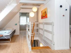 a room with a bunk bed and a staircase at Modern Holiday Home in Rømø with Sauna in Toftum