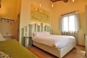 a bedroom with a large bed and a window at Podere Benintendi in Certaldo