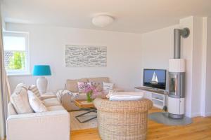 a living room with a couch and a table at Maison du Port in Timmendorfer Strand