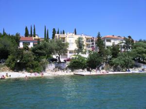 a group of people on a beach in the water at Villa Mare Crikvenica in Crikvenica