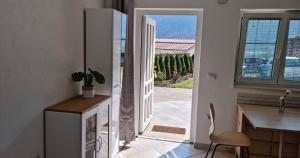 a kitchen with a door leading to a patio at Nortra apartment in Tolmin