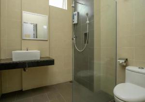 a bathroom with a shower and a toilet and a sink at Hotel 75 Temerloh in Temerloh