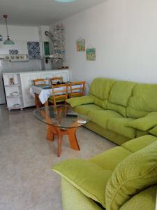 a living room with a green couch and a table at Monastery Apartment 14, St. Vlas in Sveti Vlas