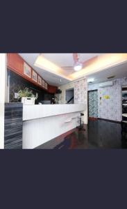 a kitchen with a white counter top in a room at Hotel 75 Temerloh in Temerloh