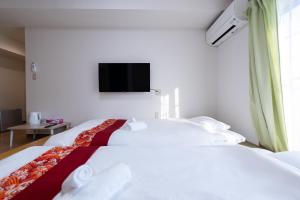 Una televisión o centro de entretenimiento en 匯金北池袋ビル