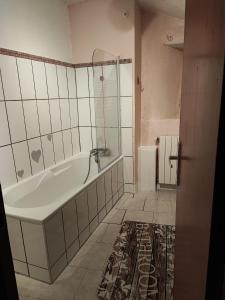 a bathroom with a tub and a shower at Apartment Le 1739 in La Coste
