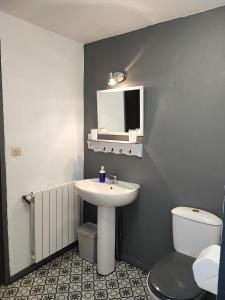 a bathroom with a sink and a toilet at Apartment Le 1739 in La Coste