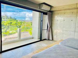 Postel nebo postele na pokoji v ubytování CONDOMINIUM 紅-BIN-