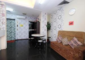 a living room with a couch and a table at Hotel 75 Temerloh in Temerloh +35 photos