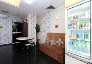 a room with a couch and a table and a drink refrigerator at Hotel 75 Temerloh in Temerloh