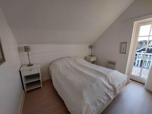 Habitación blanca con cama y ventana en Beautiful Holiday Home With Spa And Sauna Close To Nature en Gjern