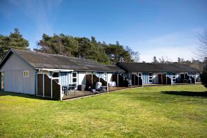a group of buildings with a large yard at Holiday Apartment In Dueodde Holiday Park in Neksø