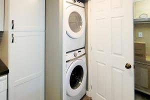 a laundry room with a washer and dryer next to a door at A Bear's Lodge #613 in Sevierville