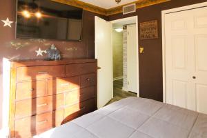 a bedroom with a large wooden dresser in a room at A Bear's Lodge #613 in Sevierville +11 photos