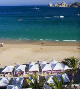 a beach with palm trees and palm trees at Pueblo Bonito Rose Resort & Spa - All Inclusive in Cabo San Lucas