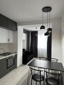 a kitchen and dining room with a table and chairs at Квартира по вул. Огієнка 2а in Lutsk