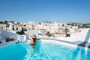 a woman in a swimming pool with a view of a city at Simantiri Private Villa in Megalochori