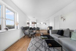 a white living room with a couch and chairs at A Lovely Holiday Home In Quiet, Scenic Surroundings in Rønne